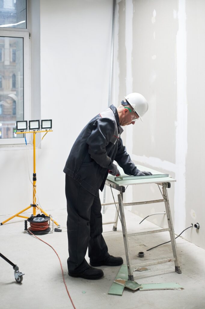Man in Uniform Cutting Drywall